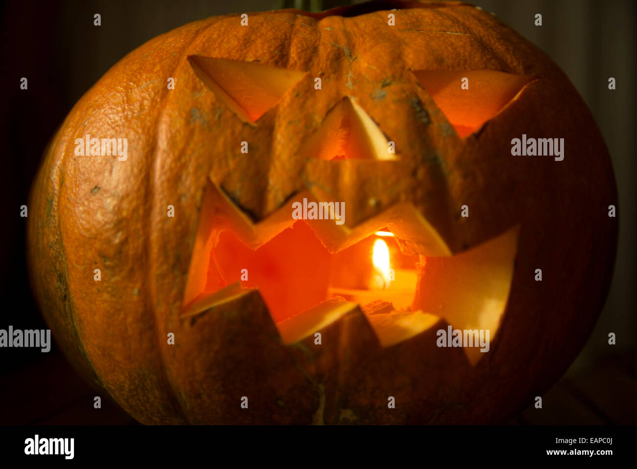 Halloween pumpkin with candle inside. Jackolantern. Carved pumpkin