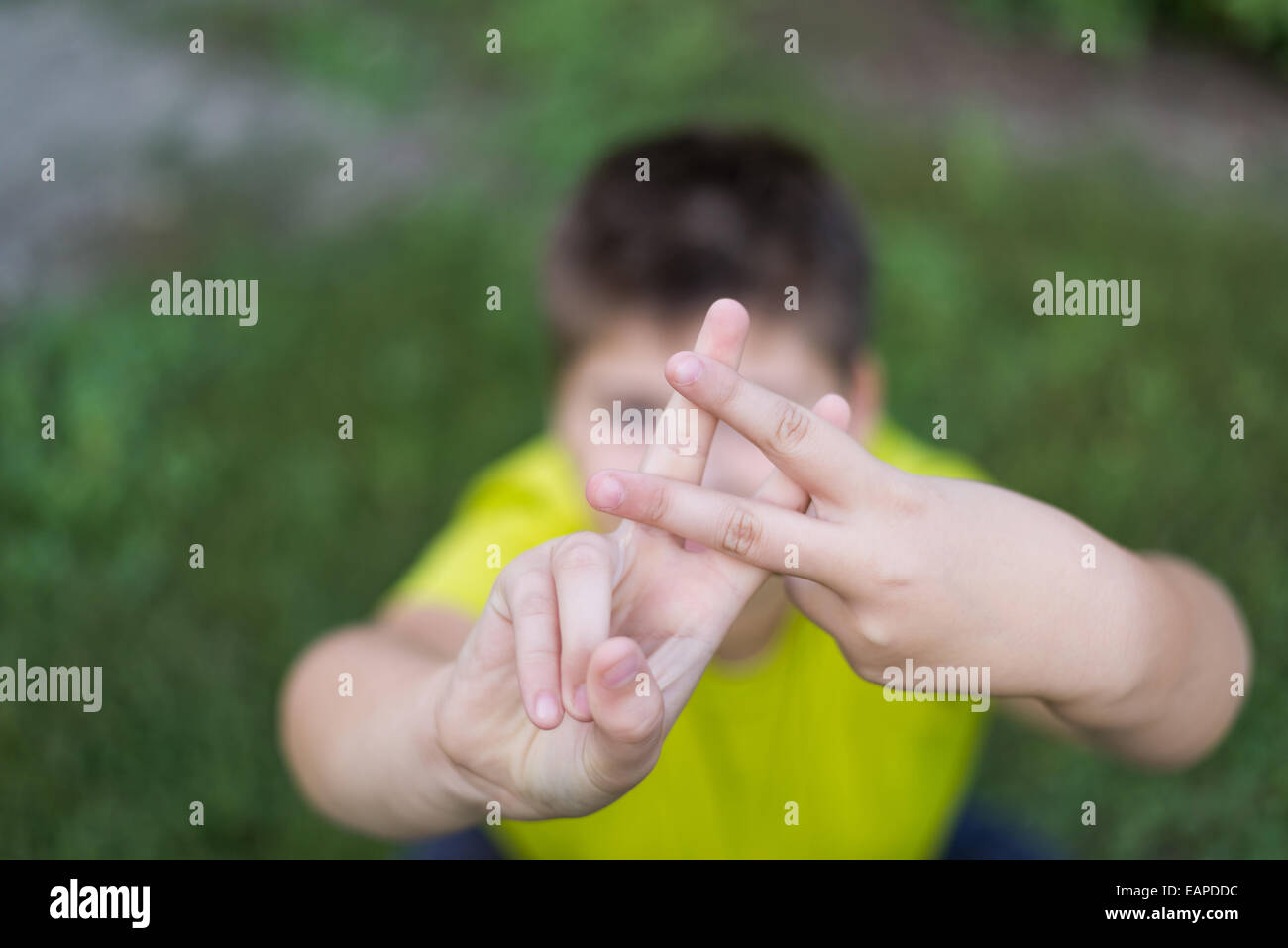 Boy shows sign gesture prison bars Stock Photo