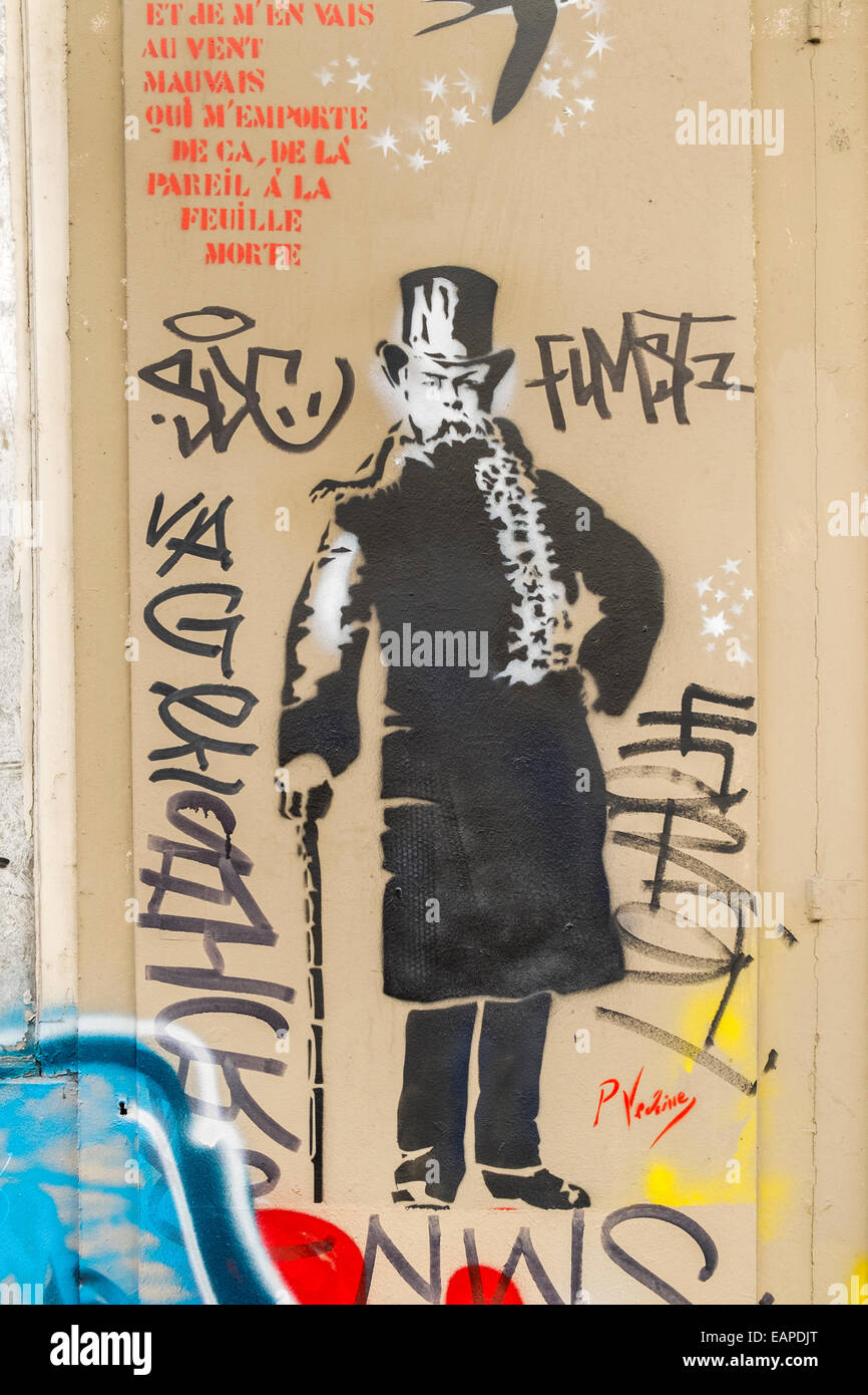 graffito showing a portrait of french poet paul verlaine next to the last verse of the poem chanson d´automne, paris Stock Photo