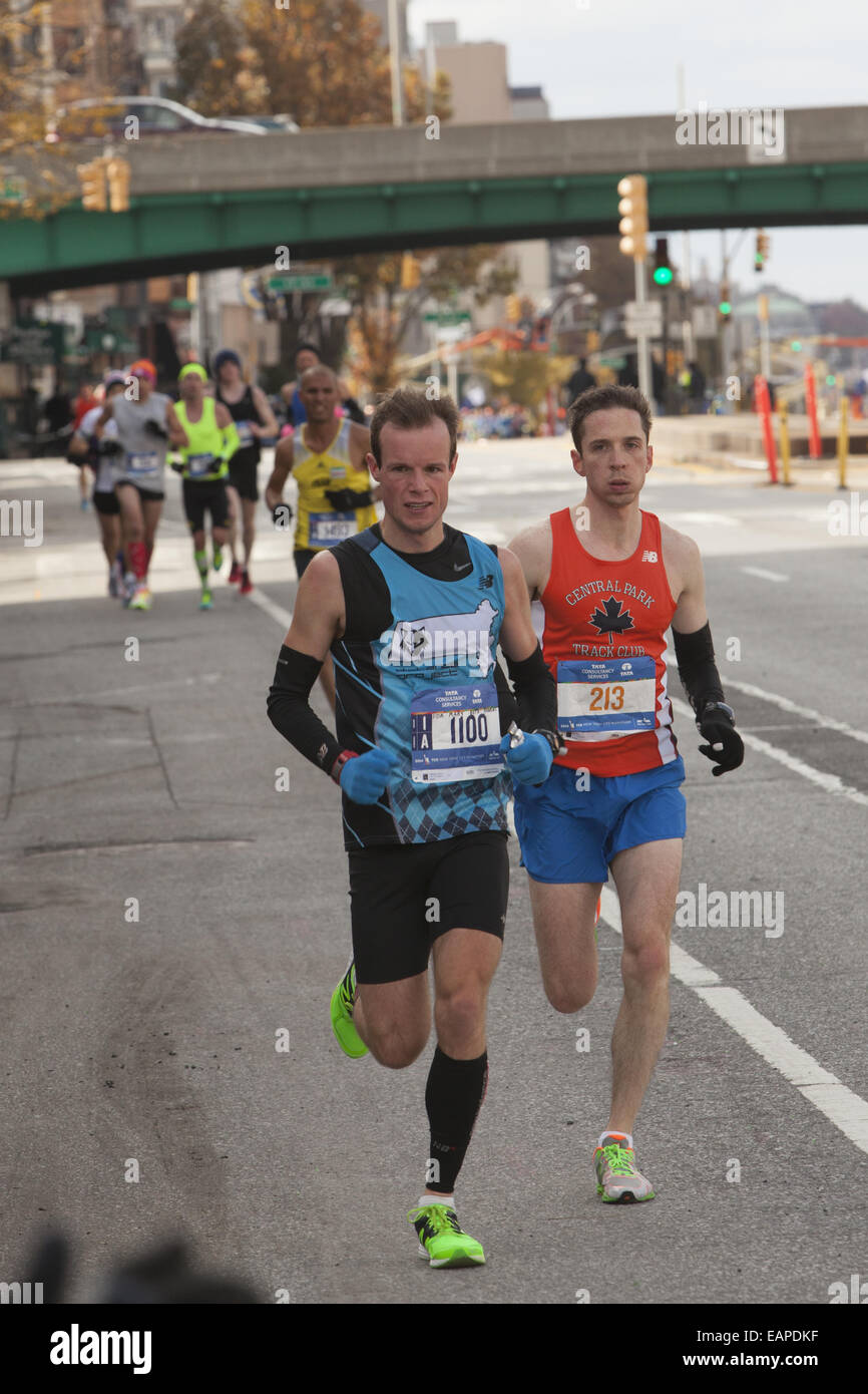 2014 NY City Marathon runners cruise along 4th Ave. in Brooklyn. Stock Photo