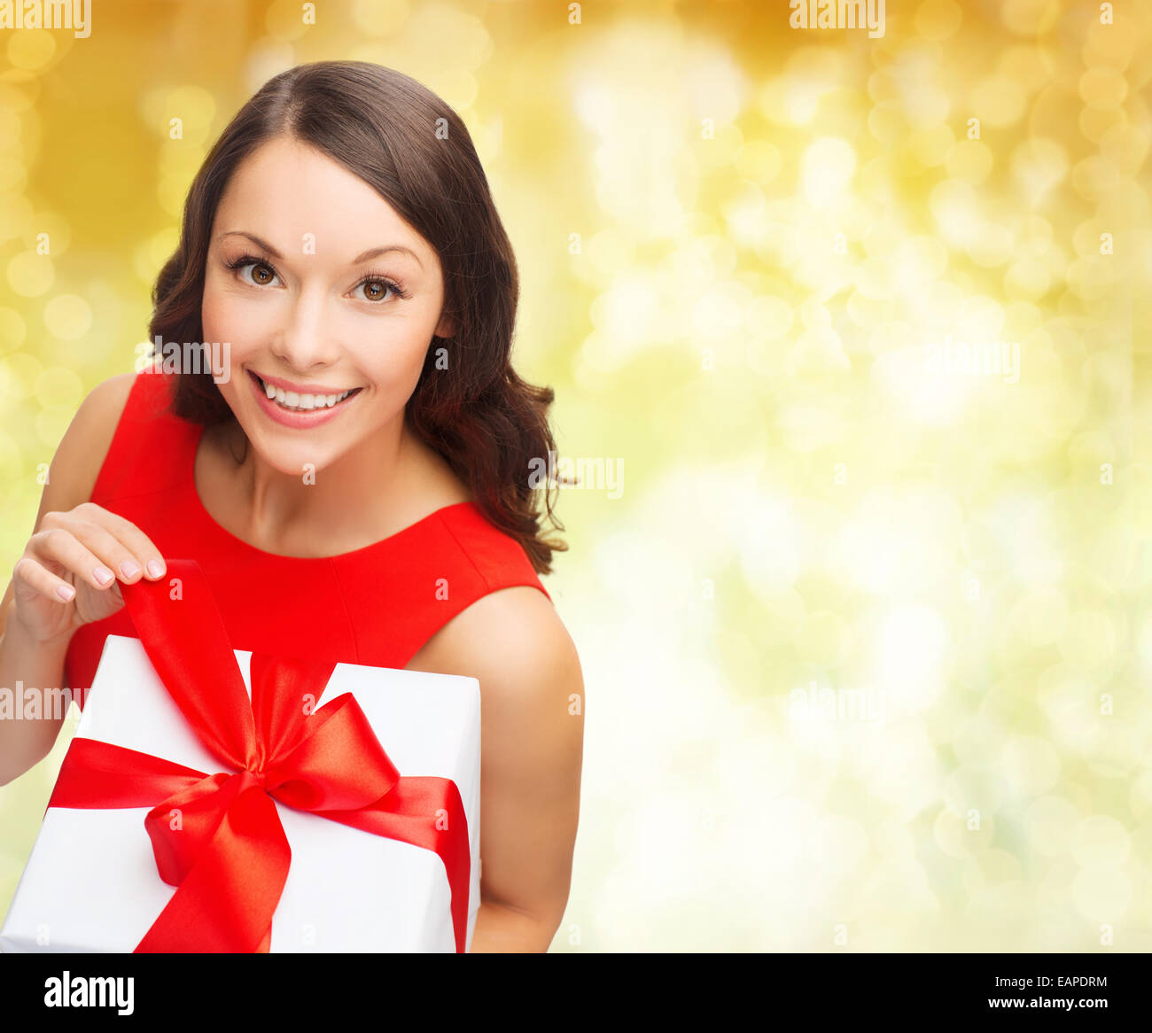 smiling woman in red dress with gift box Stock Photo Alamy