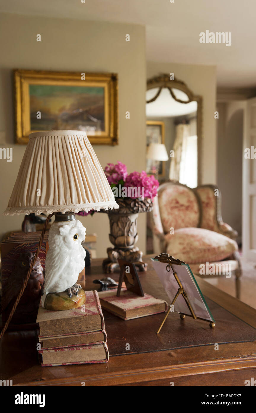 Owl lampstand on pile of antique books Stock Photo