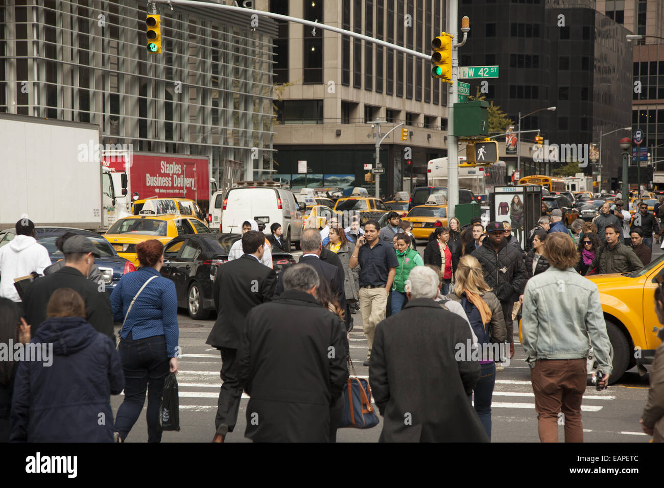 Avenue of the Americas (6th Ave.) is always crowded with pedestrians and street traffic by Bryant Park, at 42nd St., NYC. Stock Photo