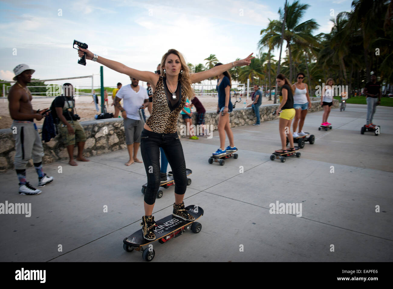 Women on motorised skateboards. Miami Beach, Florida Stock Photo