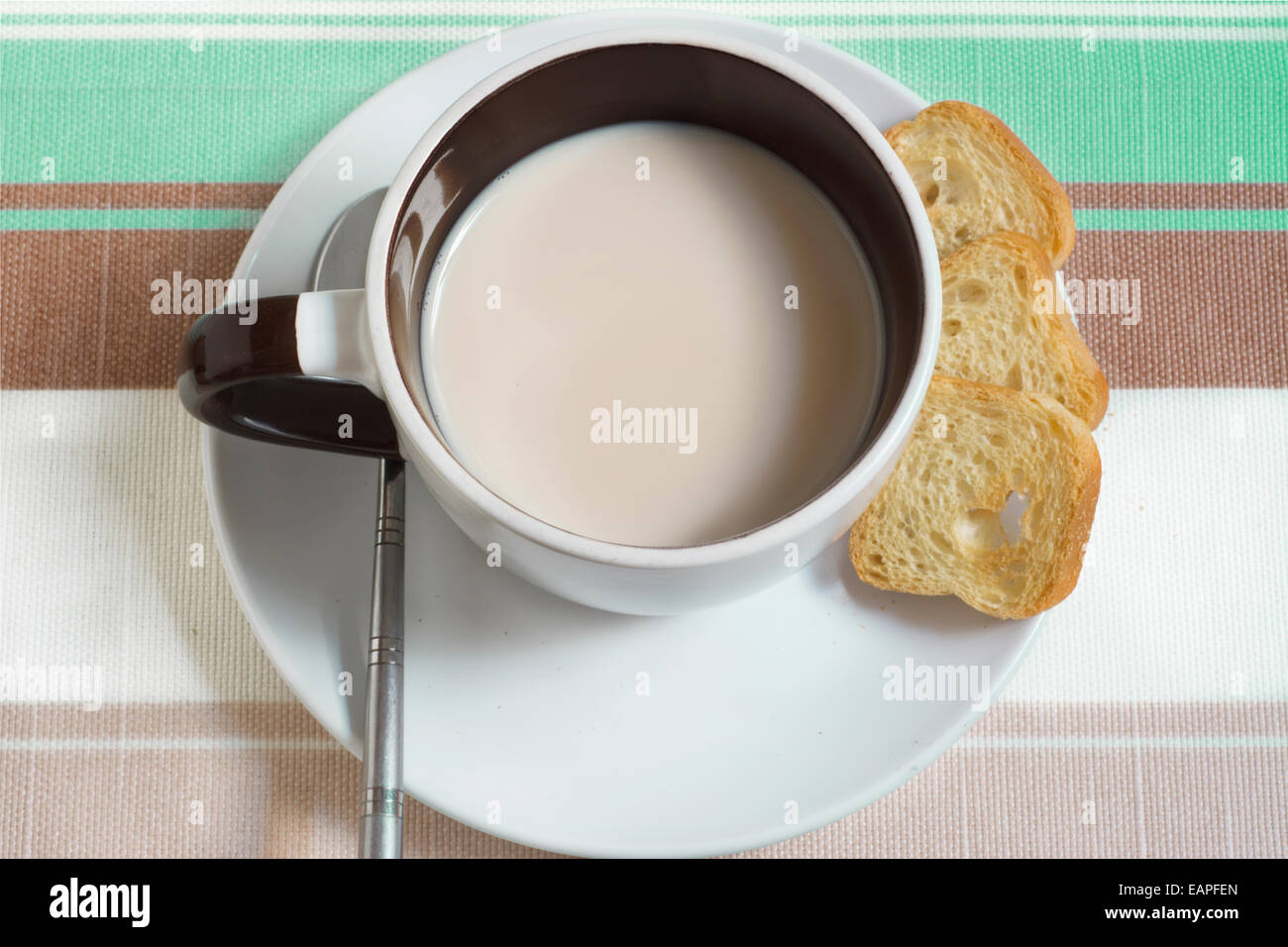 Aerial view of light breakfast, tea or coffee with milk, decorated striped background Stock Photo