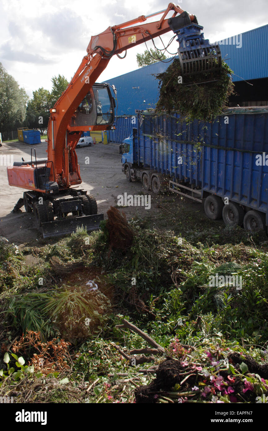 amenity tip & recycling plant, digger sorting garden waste Stock Photo