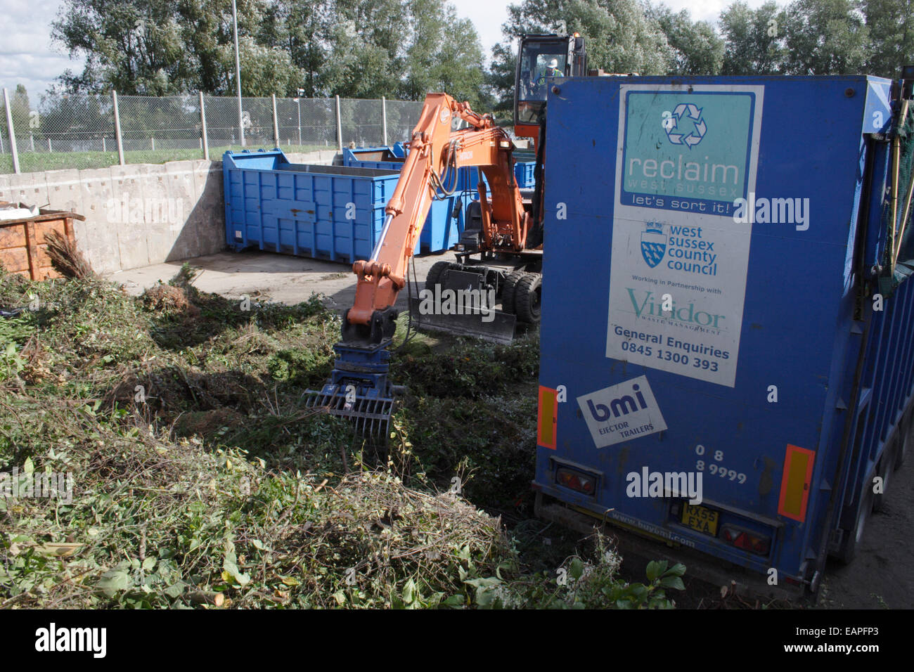 amenity tip & recycling plant, digger sorting garden waste Stock Photo