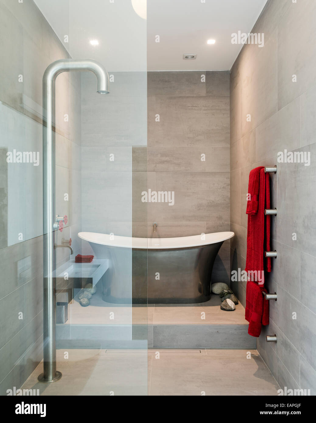 Aegean metallic platinum bath by Ashton and Bentley in bathroom with Boffi fixed floor shower Stock Photo