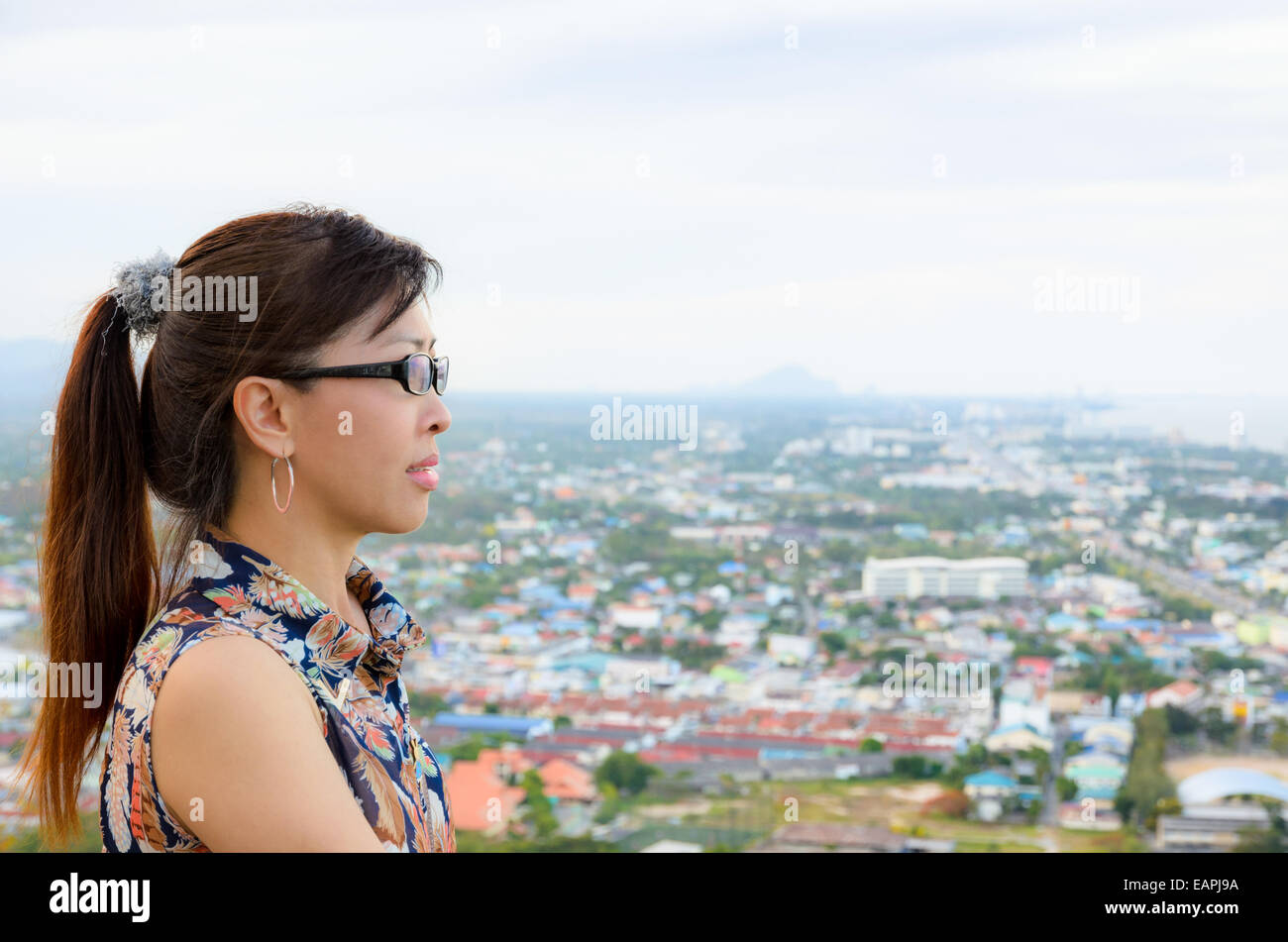 Women look at a view of the Hua Hin city from on high in Thailand Stock Photo