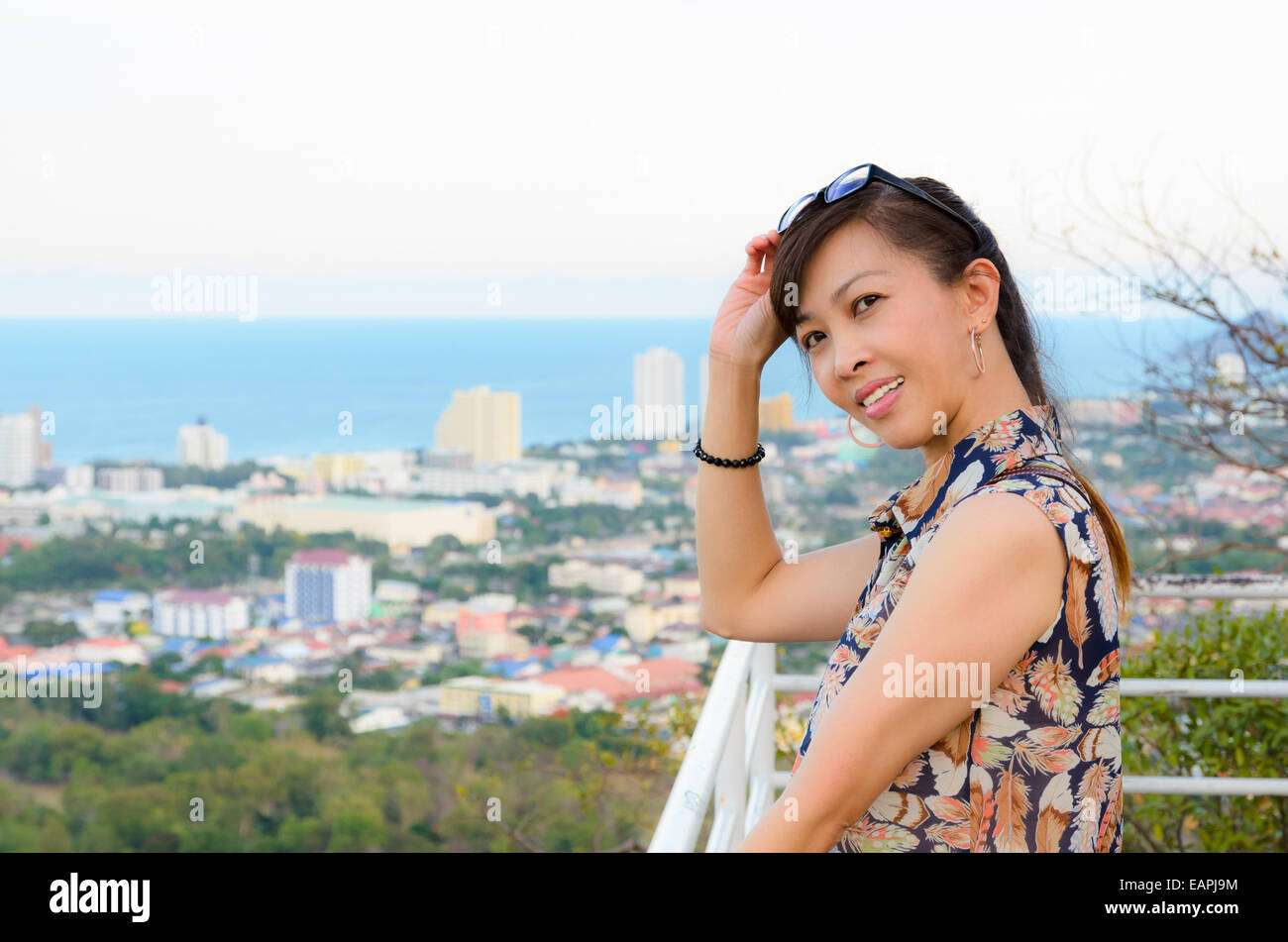 Woman poses on a high of viewpoint the Hua Hin city. Thailand Stock Photo