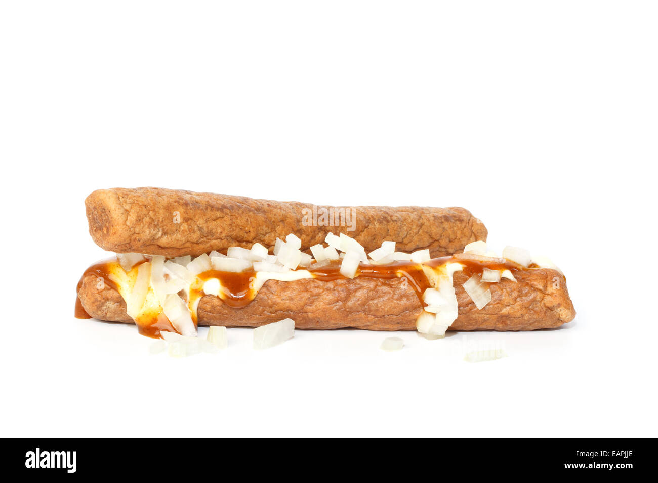 Two frikandellen speciaal, a Dutch fast food snack, with mayonnaise, curry sauce and chopped onions Stock Photo