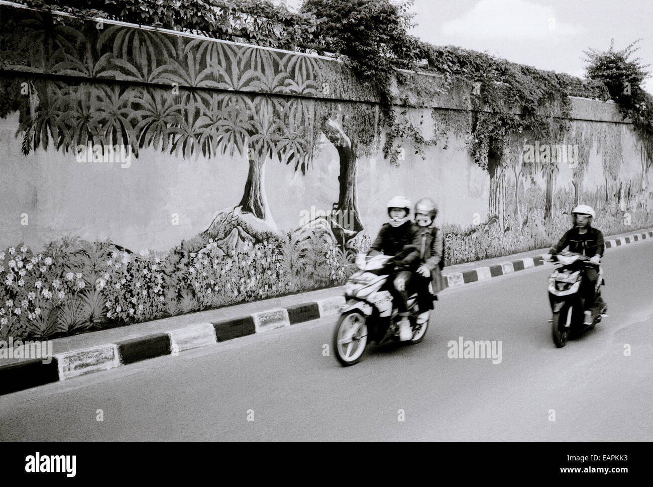 Street scene in urban Yogyakarta in Java in Indonesia in Southeast Asia Far East. b&w Travel Stock Photo