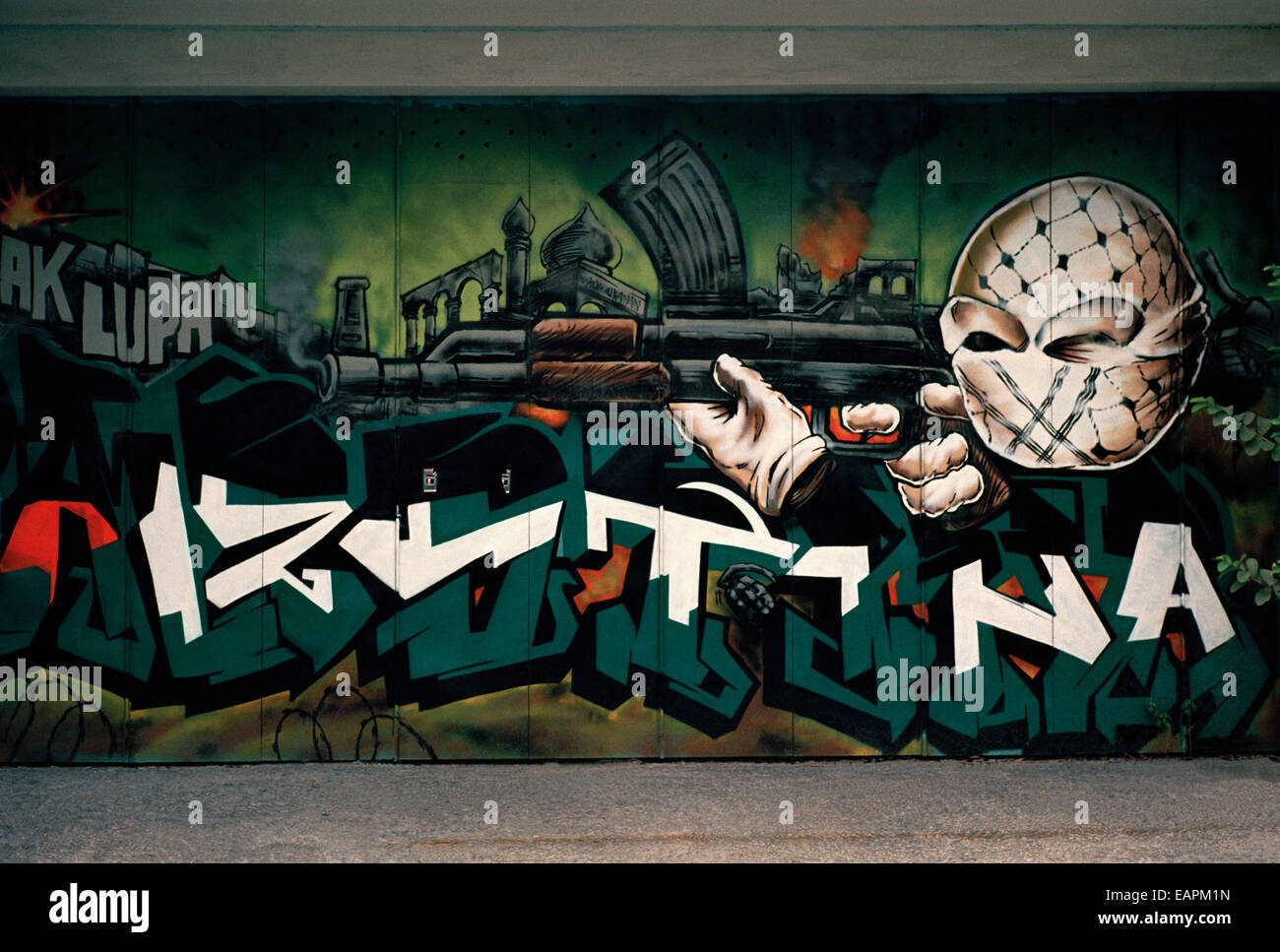 Terrorist freedom fighter graffiti street art in Yogyakarta in Java in Indonesia in Southeast Asia Far East. Gun Attack Attacker Shoot Palestinian Stock Photo