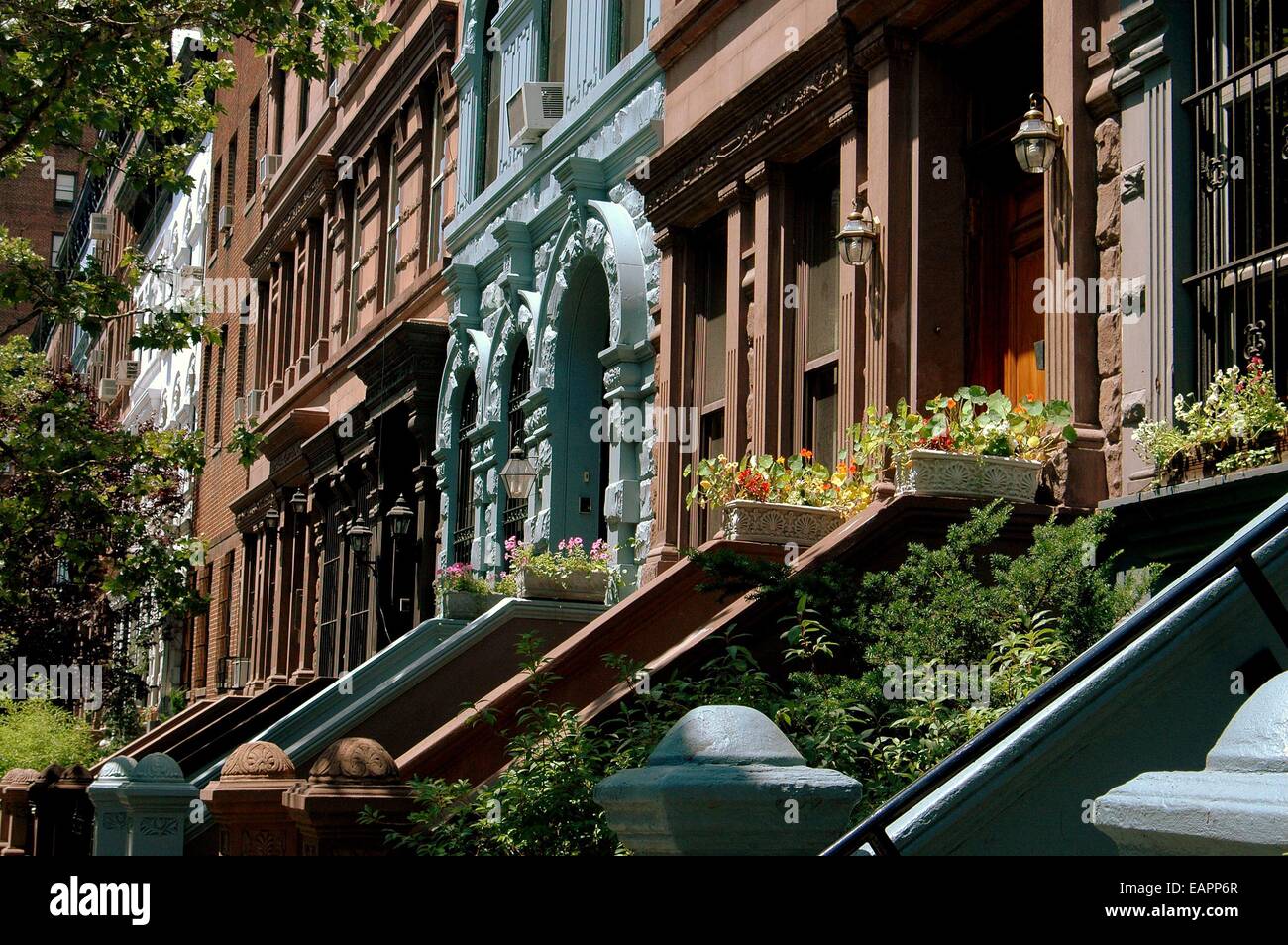 NYC: A row of classic late 19th century brownstones with staircase stoops on West 78h Street on the Upper West Side Stock Photo