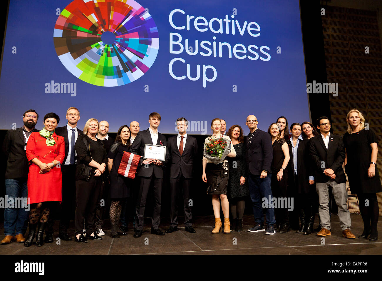 Copenhagen, Denmark, November 19th, 2014: Winner of the Creative Business Cup finals, CTAdventure, Poland (holding sign and flowers),   and jury members together with HRH Crown Prince Frederik (photo, mid with red tie). The winners competed with national champions for young creative entrepreneurs in 55 countries Stock Photo