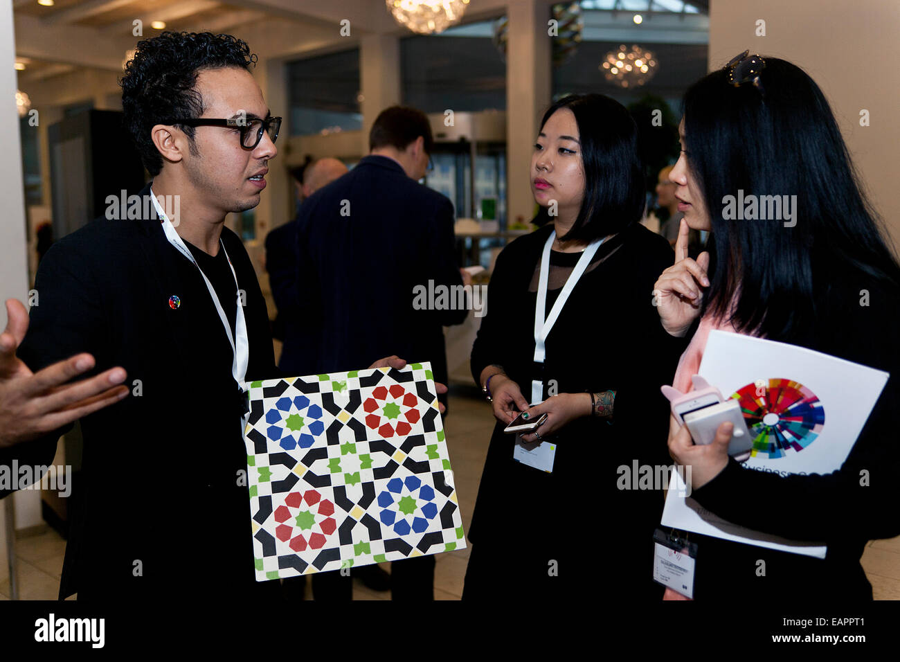 Copenhagen, Denmark, November 19th, 2014: Young creative entrepreneurs meets in Copenhagen in their quest for being the world best in the international “Creative Business Cup”. But they also meets for sharing ideas and being motivated by their fellow competitors. Here Abdelilah Elomari (photo, left) from the Moroccan design company, Origami, discuss ideas with competitors from China Stock Photo