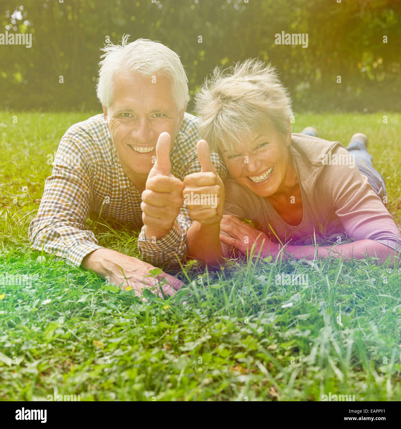 Happy senior couple holding thumbs up to congratulate Stock Photo - Alamy