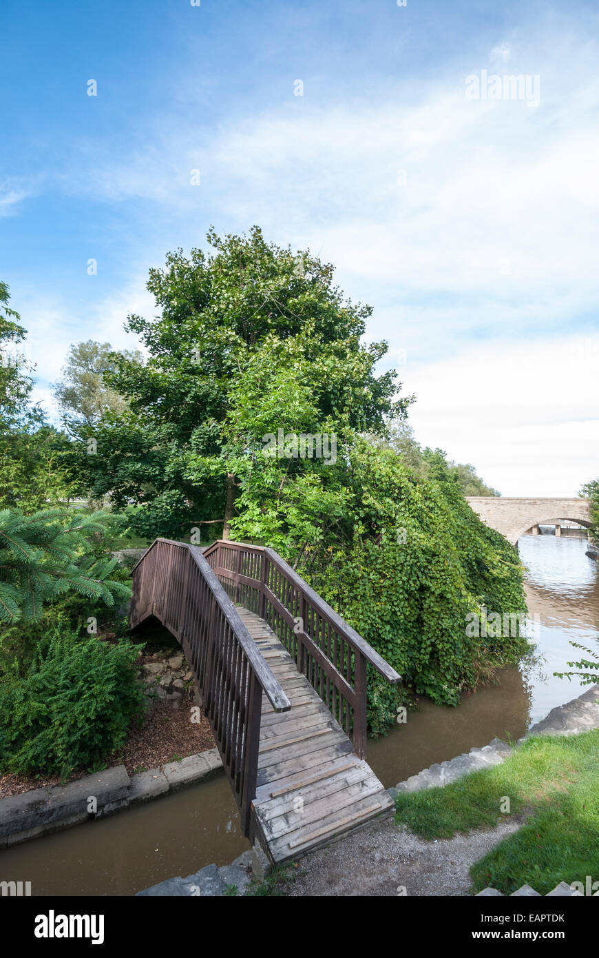 A unique curved wooden bridge at the Shakespearian gardens in Stratford Ontario Canada Stock Photo