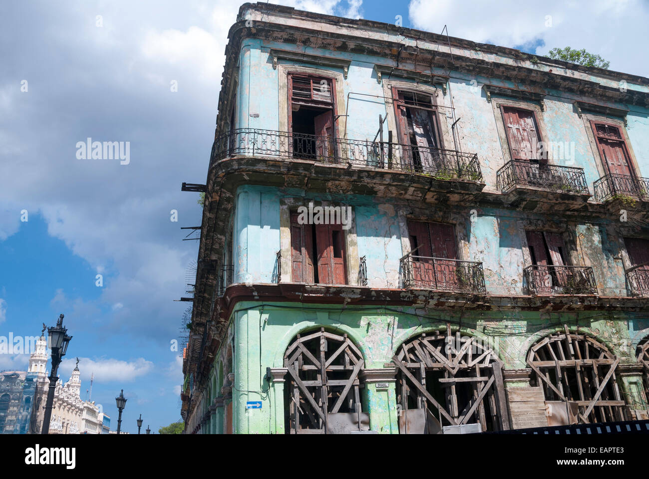 A rundown and dilapidated apartment building on a side street opposite the Capitol building in central Havana Cuba Stock Photo