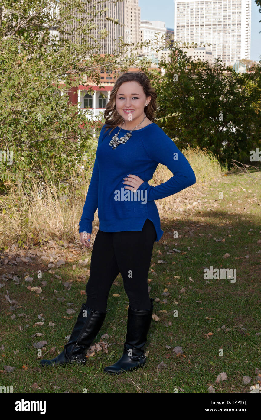Full length portrait of young teen female outdoors smiling with downtown saint paul in background Stock Photo