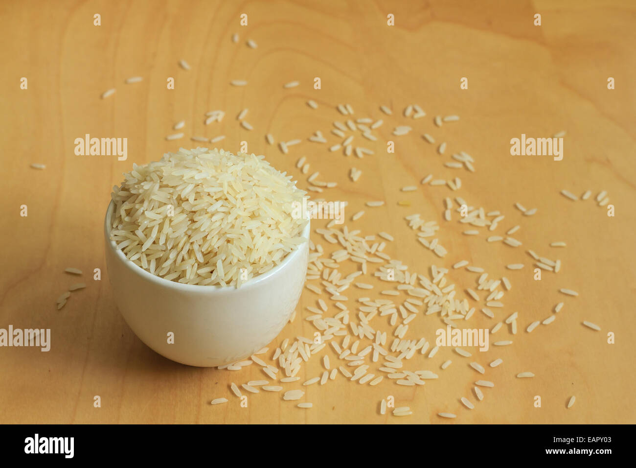 rice in cup on wooden background Stock Photo