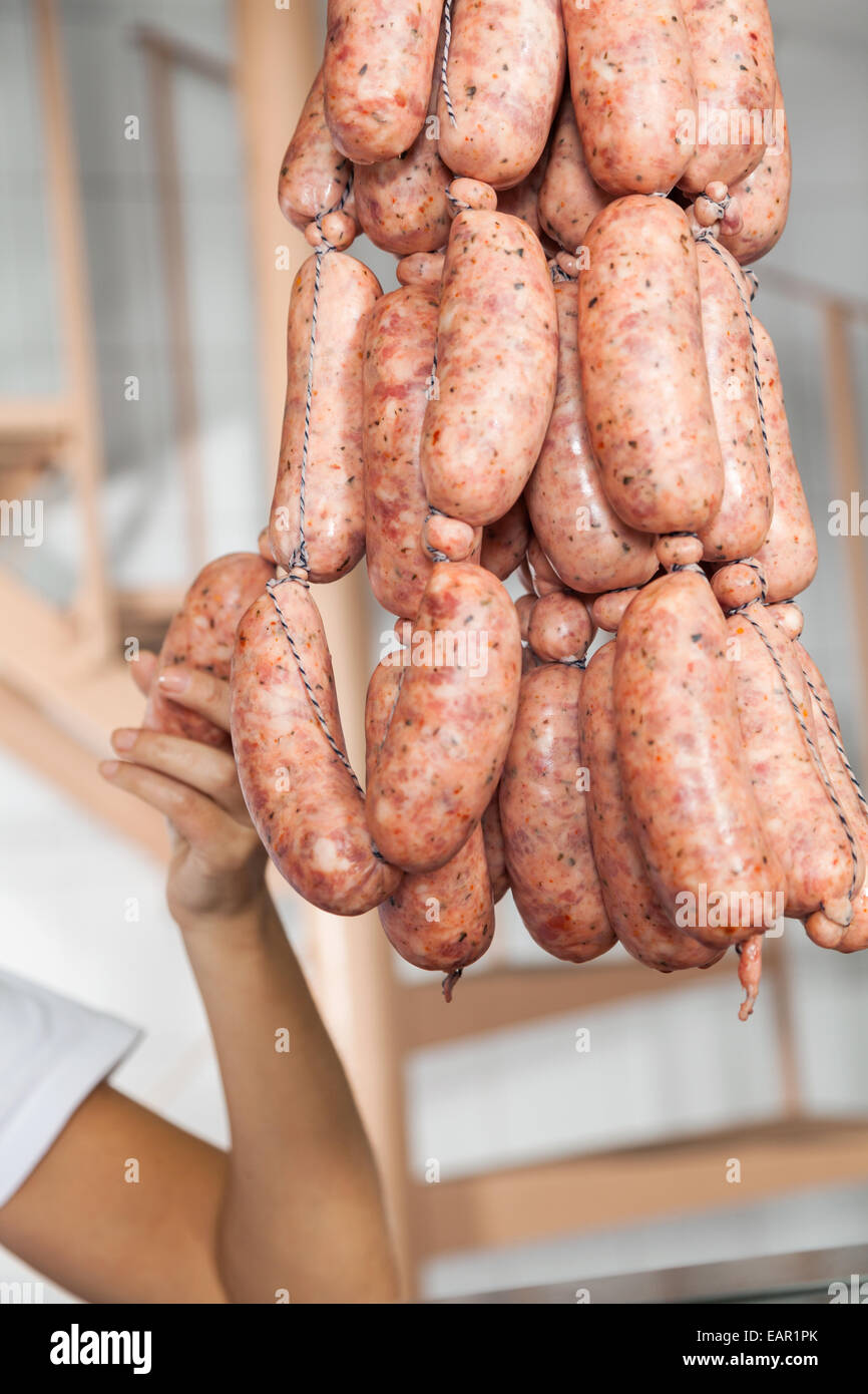 Butcher Holding Sausages In Butchery Stock Photo
