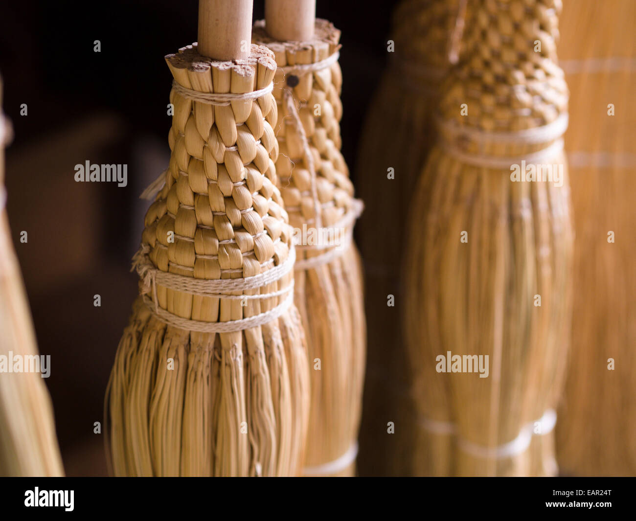 The fancy braided and tied handmade corn brooms. Hand made brooms made in a little shop in Upper Canada Village. Stock Photo