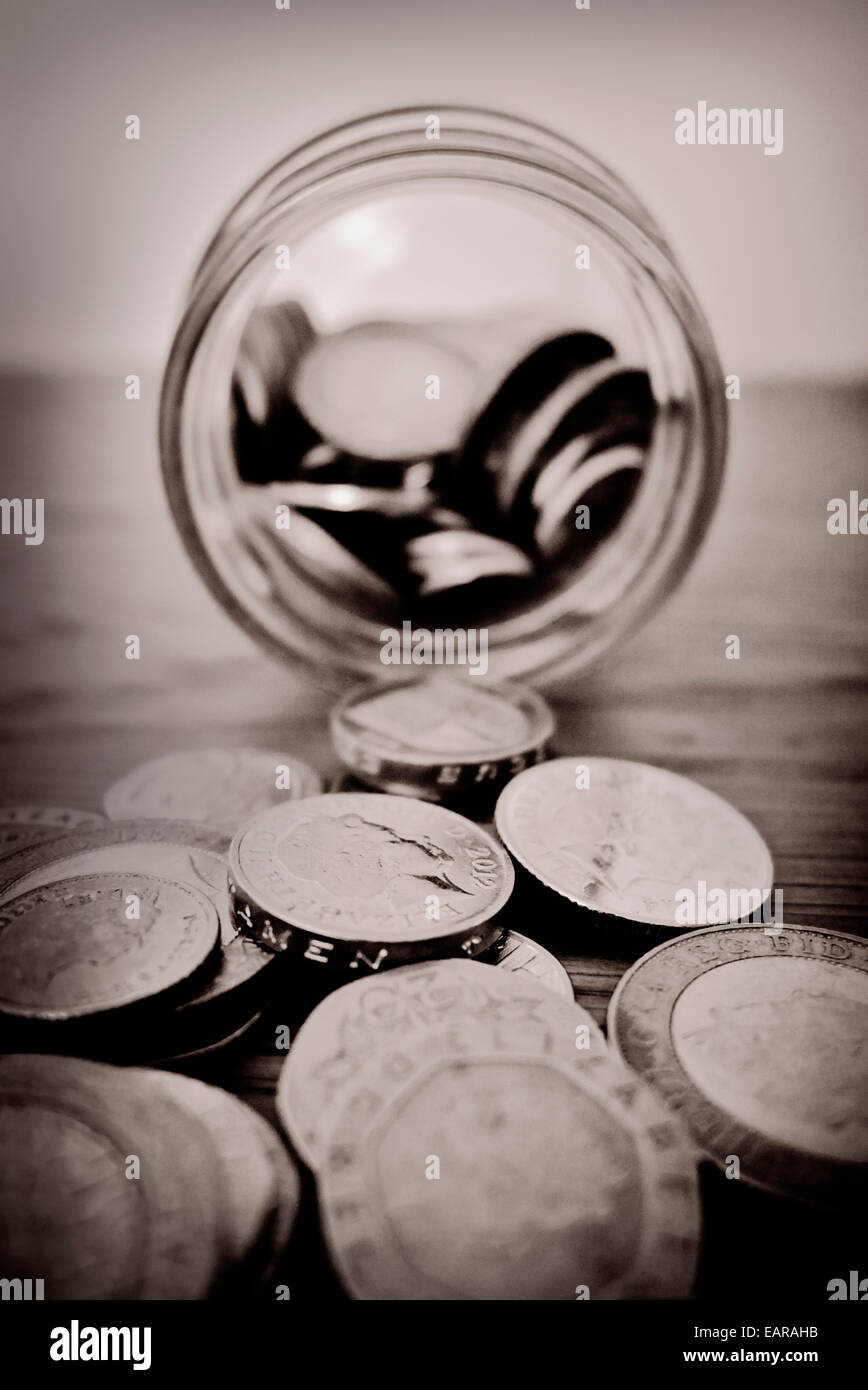 Emptying savings jar. Stock Photo