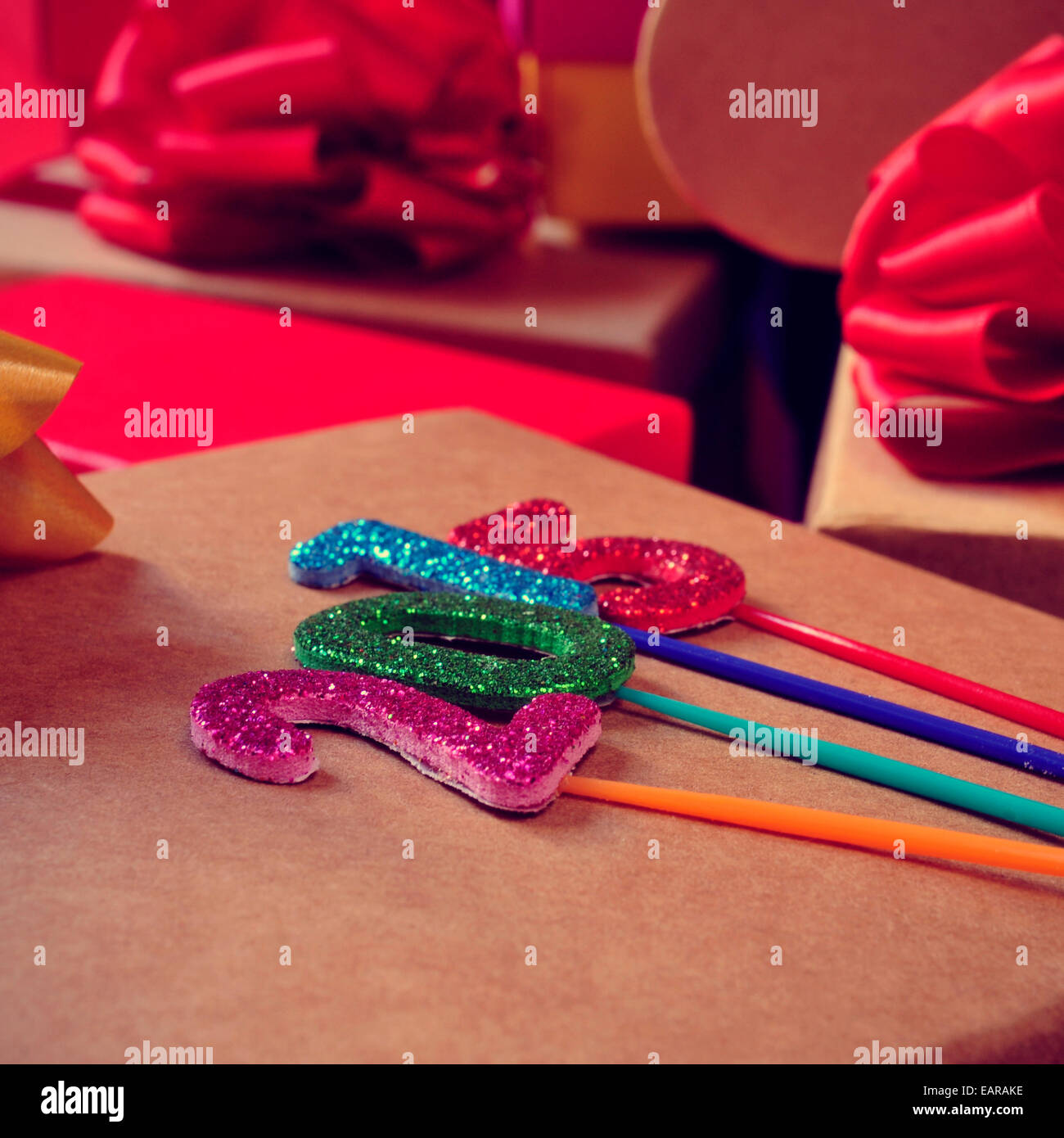 numbers of different colors forming the number 2015, as the new year, with a pile of gifts in the background Stock Photo