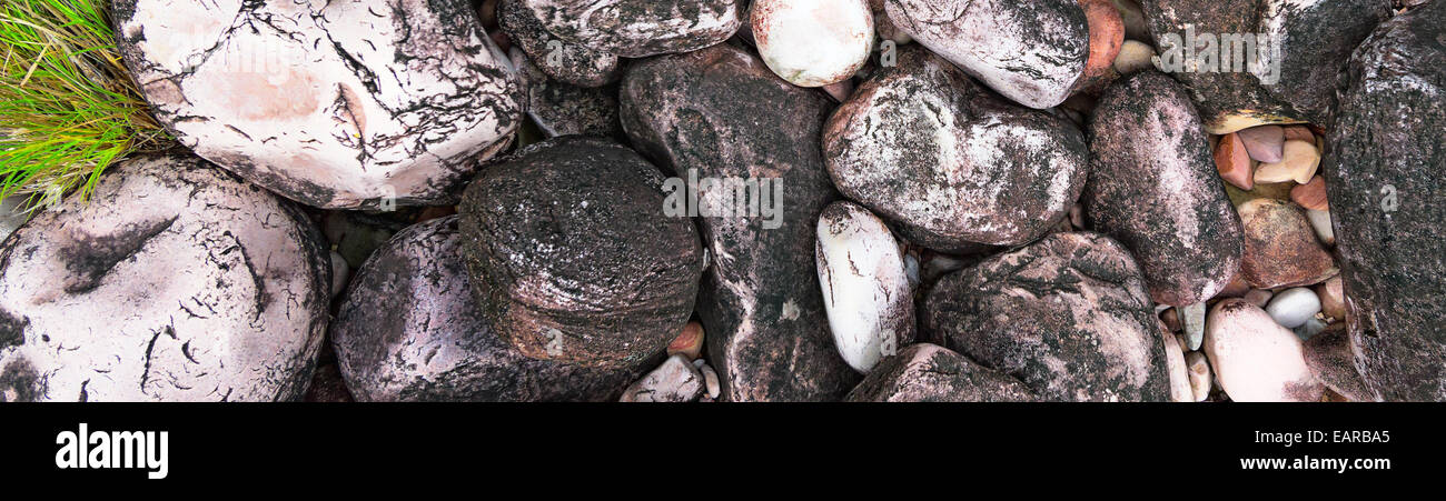 Close-up of colored river pebbles on the shore of a mountain stream. Stock Photo