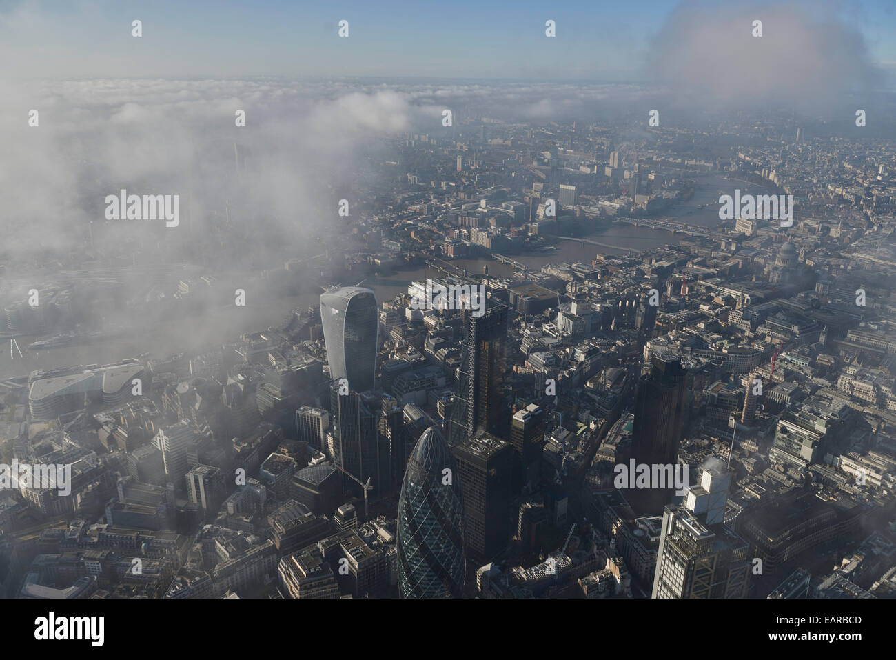 An aerial view of the City of London looking towards the River Thames amid low cloud Stock Photo