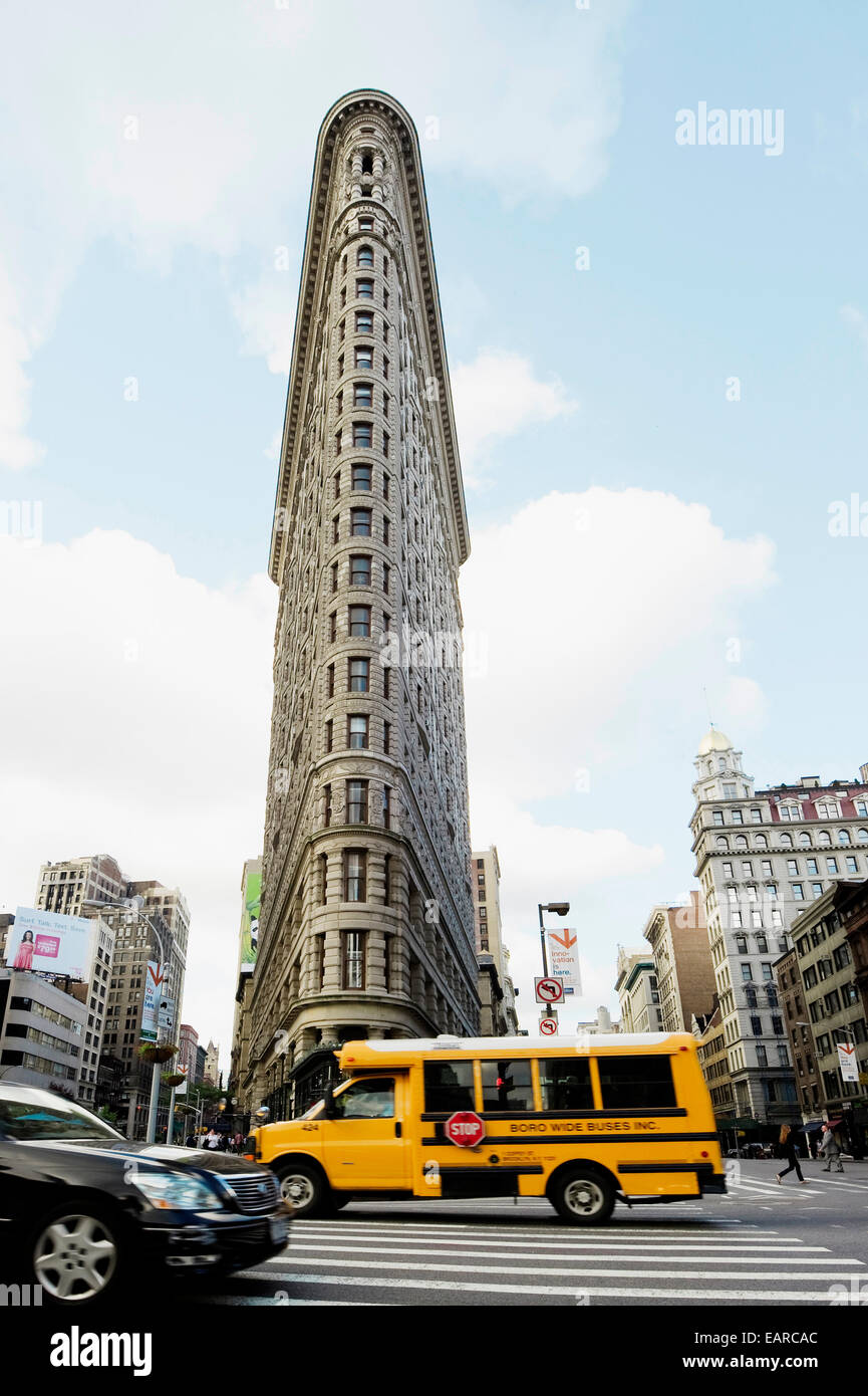 Broadway with a school bus and the Flatiron Building, Manhattan, New York City, New York, United States Stock Photo
