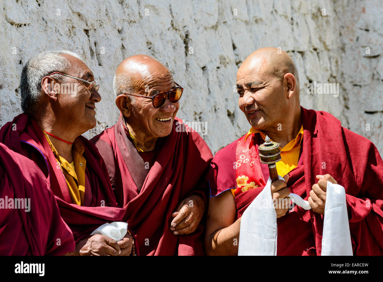 Three monks in the courtyard of Lamayuru Gompa, Ladakh, Jammu and Kashmir, India Stock Photo