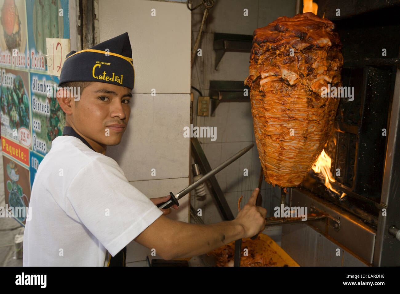 Young man preparing tacos al pastor, Puebla, Puebla, Mexico Stock Photo