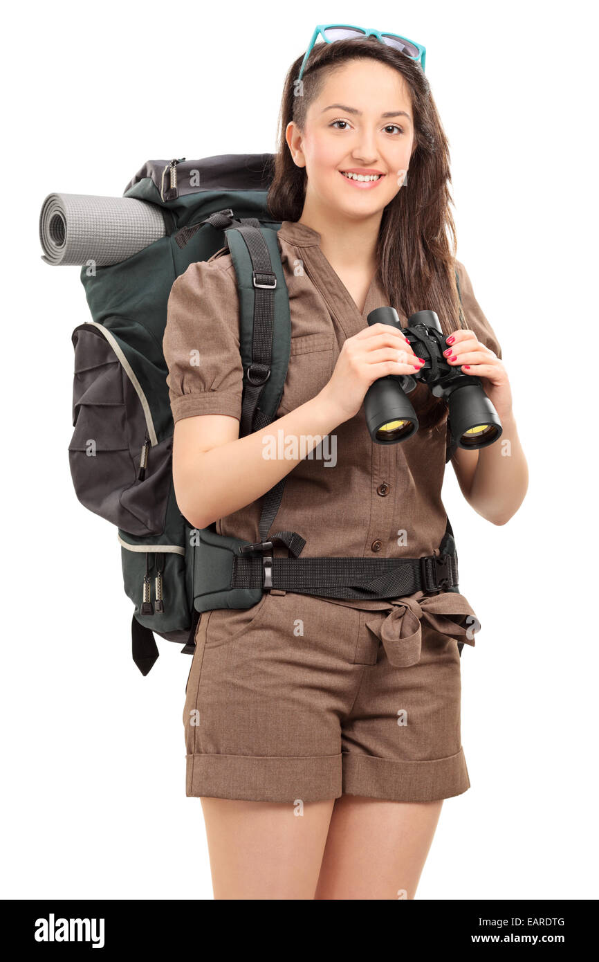 Vertical shot of a female hiker holding binoculars isolated on white background Stock Photo