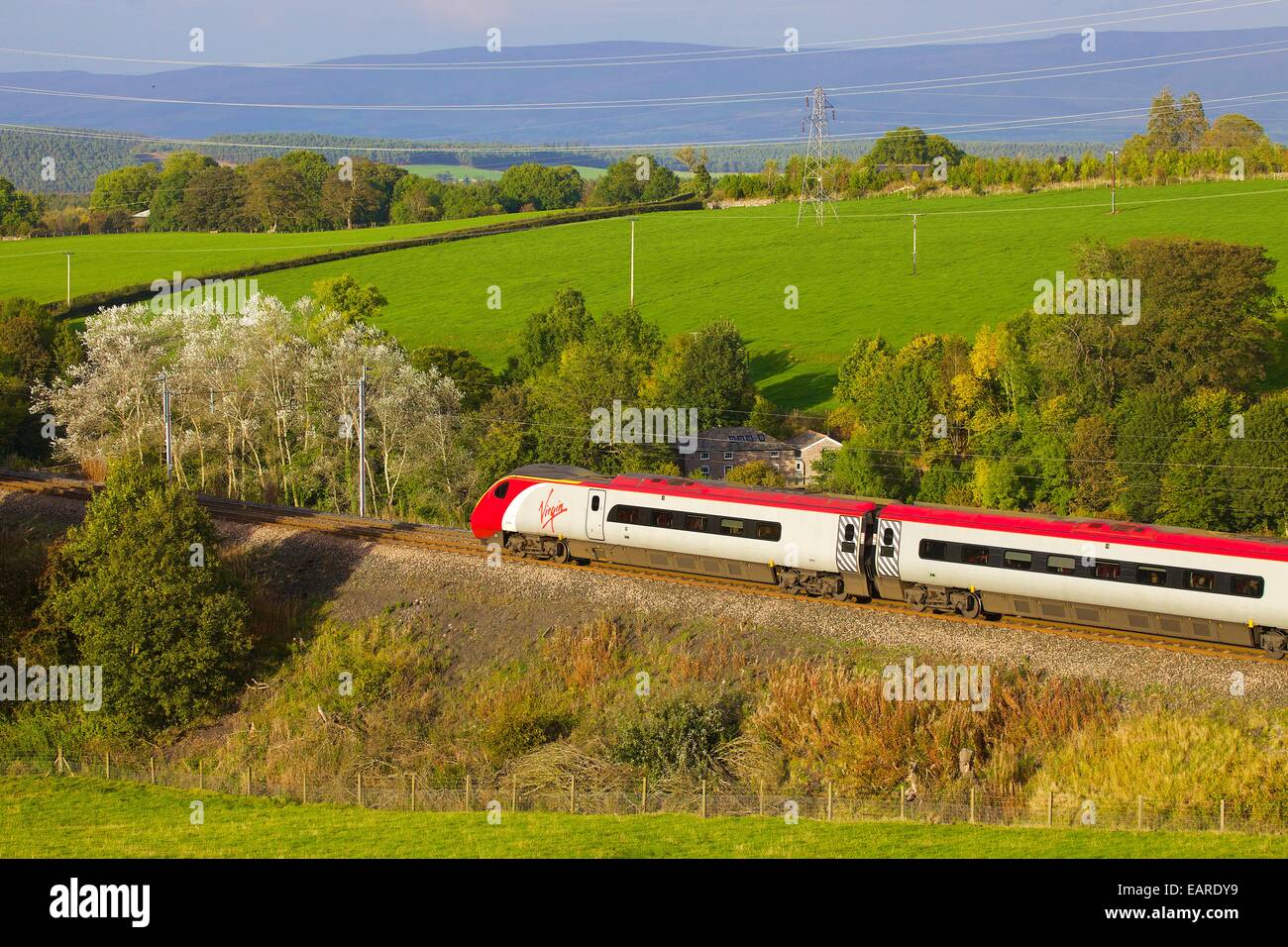 Class 390 Pendolino Virgin train passing Strickland Mill, Great Strickland, Cumbria, West Coast Main Line, England, UK. Stock Photo