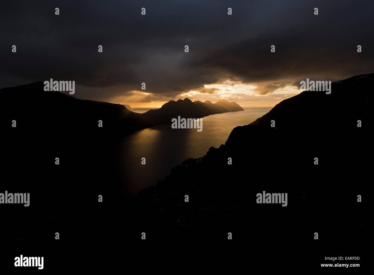Dramatic mood lighting over the islands of Kalsoy and Kunoy, Borðoy, Norðoyar, Faroe Islands, Denmark Stock Photo