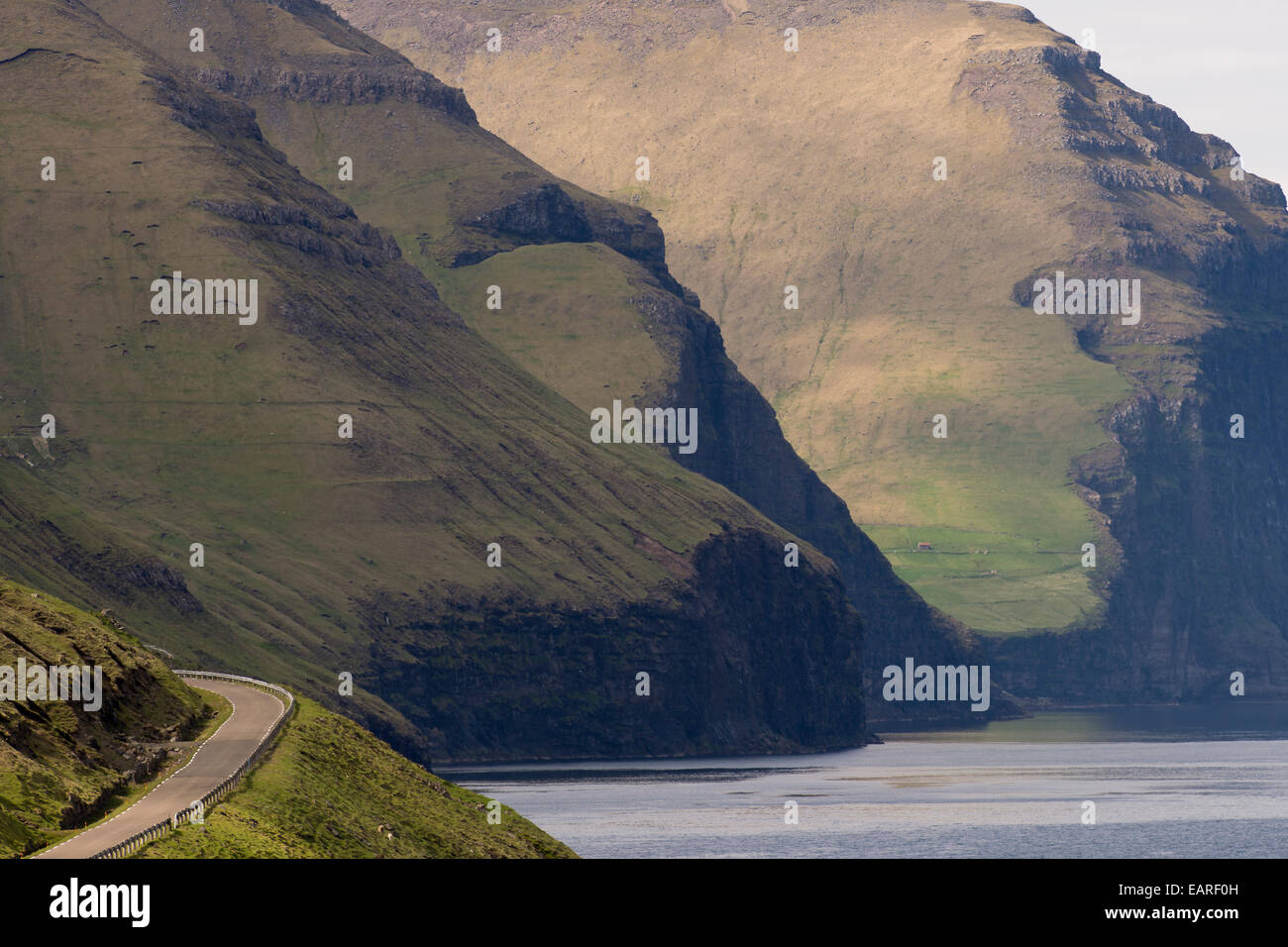 Road and mountains towering from the sea, Kalsoy, Norðoyar, Faroe Islands, Denmark Stock Photo