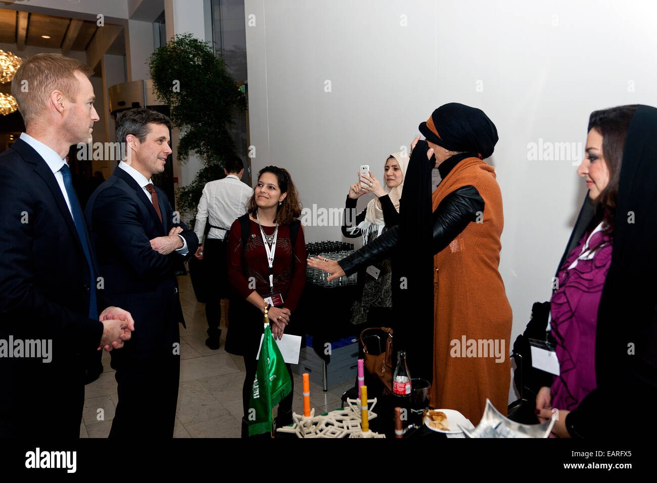 Copenhagen, Denmark, November 19th, 2014: The Danish Crown Prince Frederik (photo, 2nd left) meets representatives from the Saudi Arabian start-up company Marou during the Creative Business Cup (CBC) final in Copenhagen. The company won the national Saudi Arabian CBC competition for young creative entrepreneurs with their electronic incense stick. In this way they were qualified to participate in the CBC world finals in Copenhagen. “ Incense smoke is an important part of social life in Arab countries and this handy one you can carry everywhere,” they explained to the Crown Prince. Stock Photo