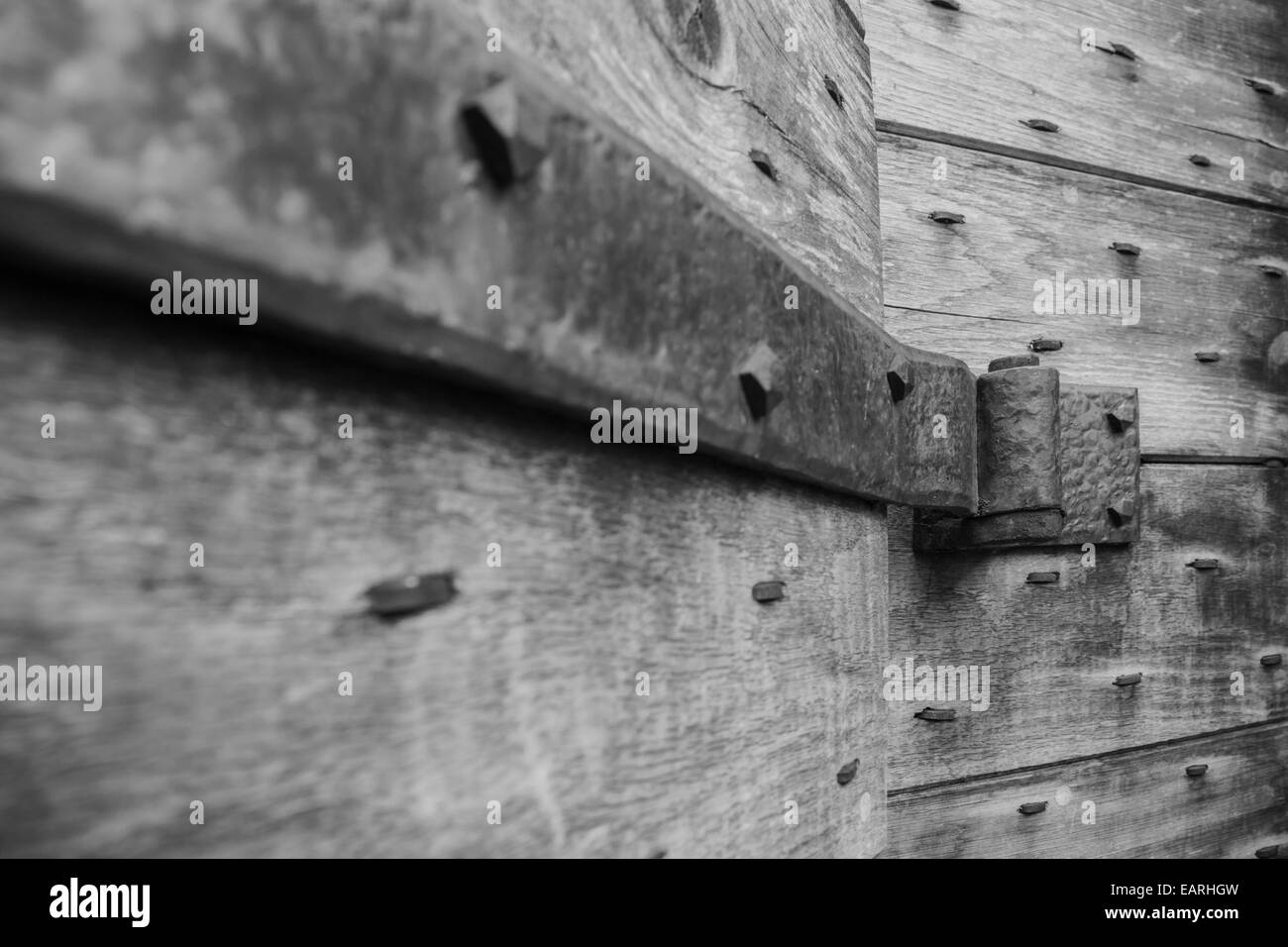 Steel strap hinge supporting a solid oak door. Stock Photo
