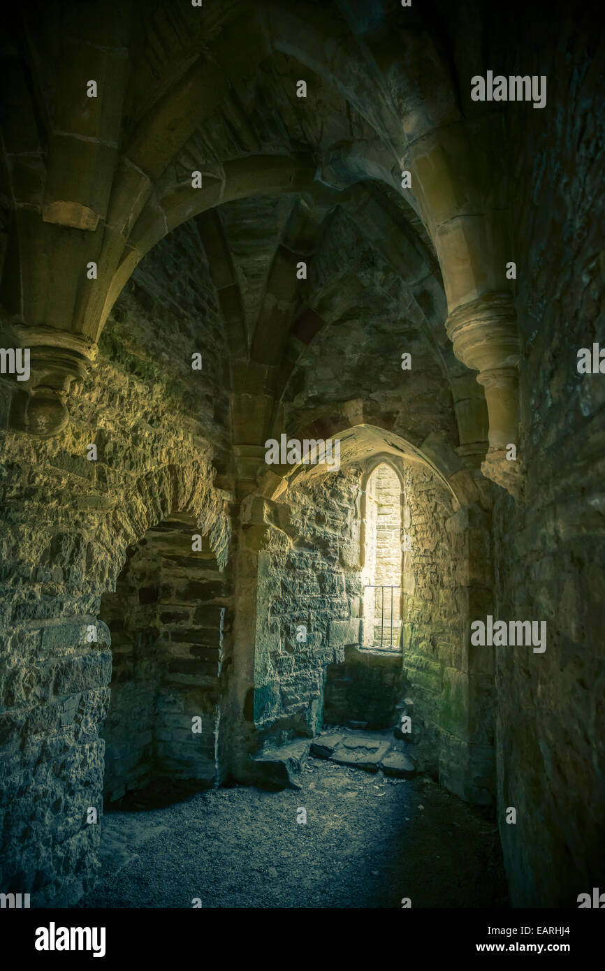 Stone room with a vaulted ceiling and arched window. Stock Photo