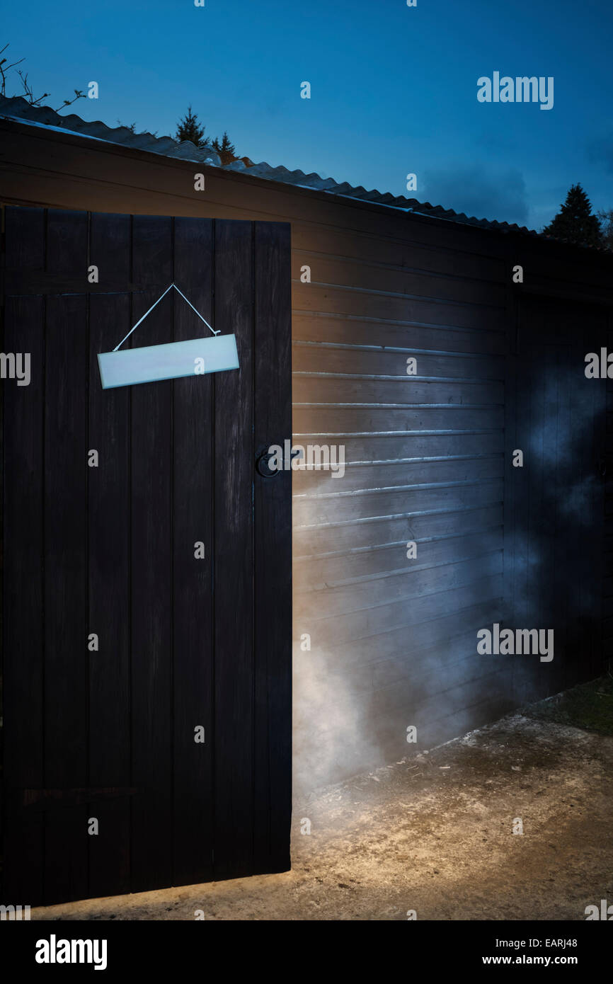 Smoke pouring from an open door. Stock Photo