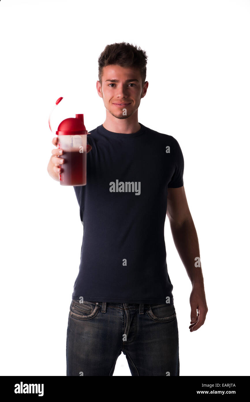 Attractive young man or teenager holding protein shake bottle. Isolated on white, smiling and looking at camera Stock Photo