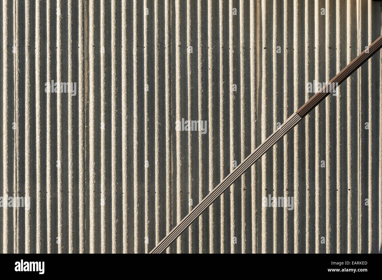 Corrugated Metal Wall With Angled Downspout Stock Photo