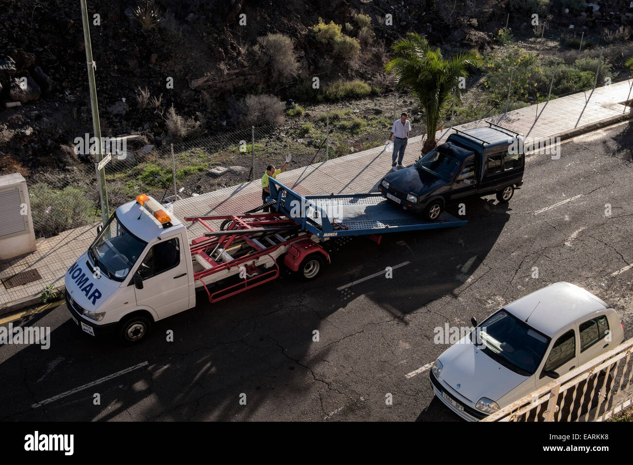 Breakdown rescue truck loading van on to the back for transport to garage. 1 of 3 in sequence. Stock Photo