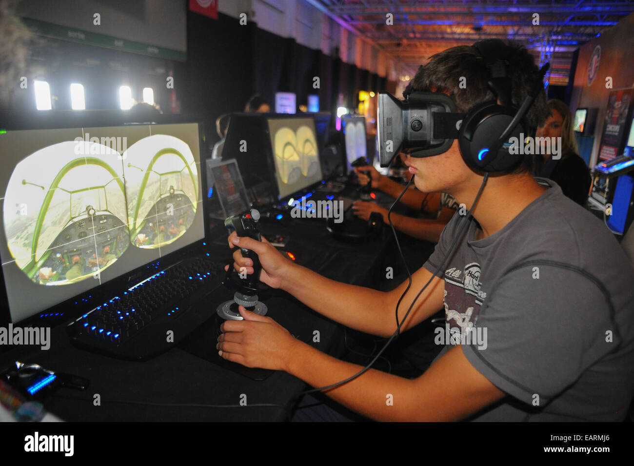 August 13, 2014 - Paris, France:  A video game player tries the Oculus Rift, a 3D virtual reality headset. The computer screen d Stock Photo