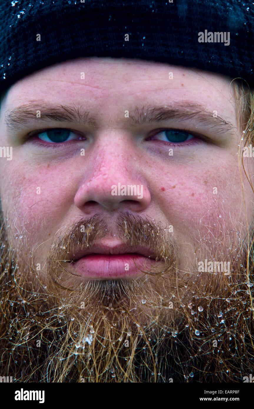 Snow melting in the beard of a serious looking tourist in Antarctica. Stock Photo
