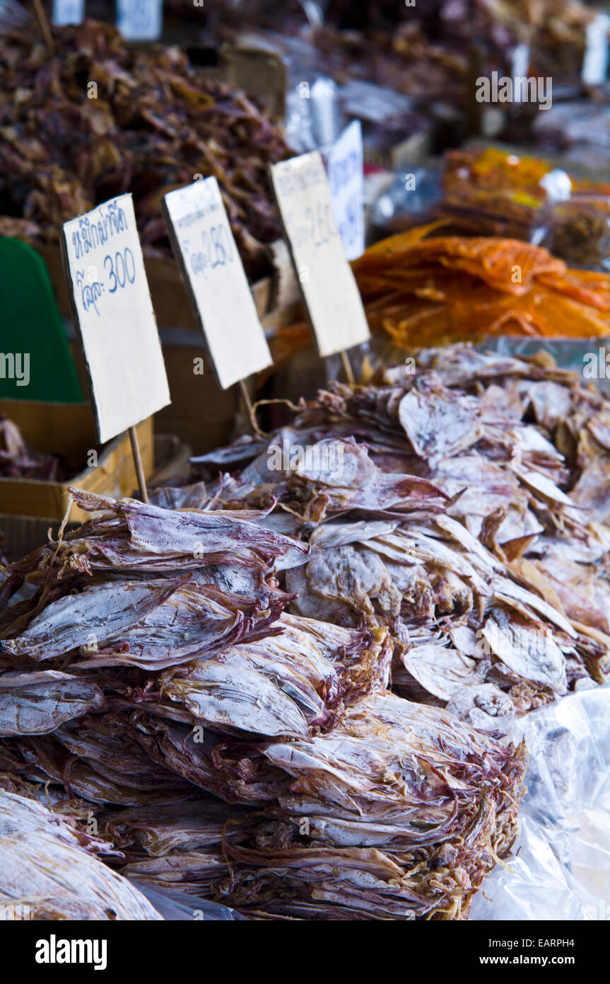 Piles of dried squid and seafood for sale in an open air market. Stock Photo