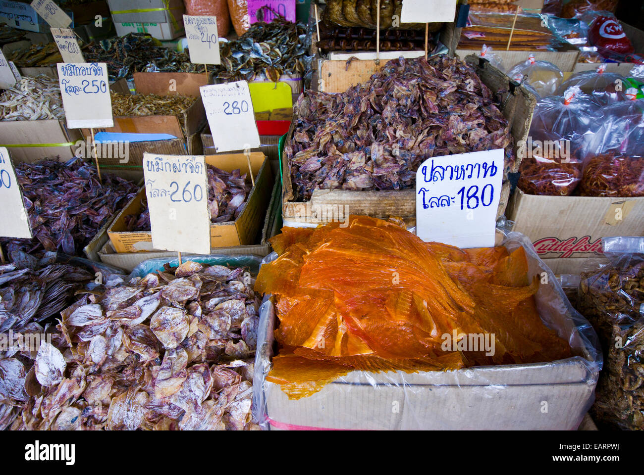 Piles of dried fish and seafood for sale in an open air market. Stock Photo