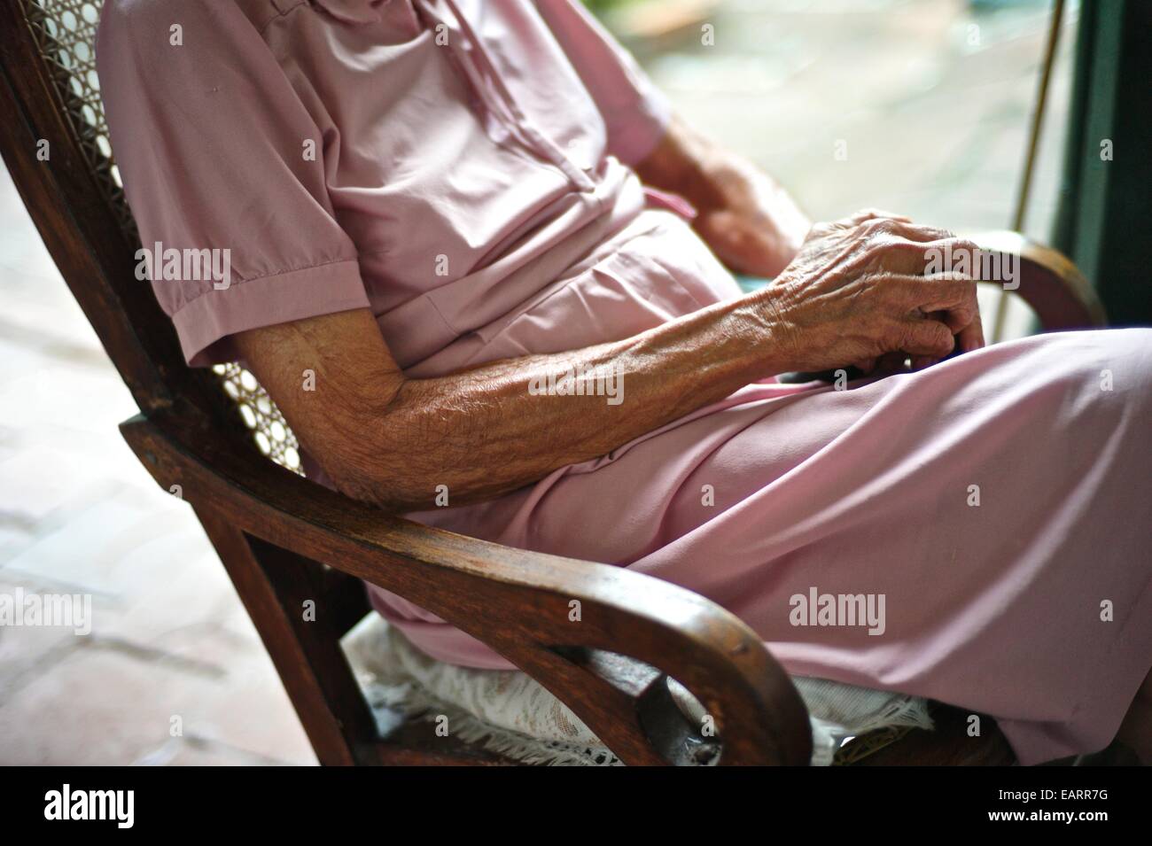 Elder woman on a rocking chair Stock Photo - Alamy